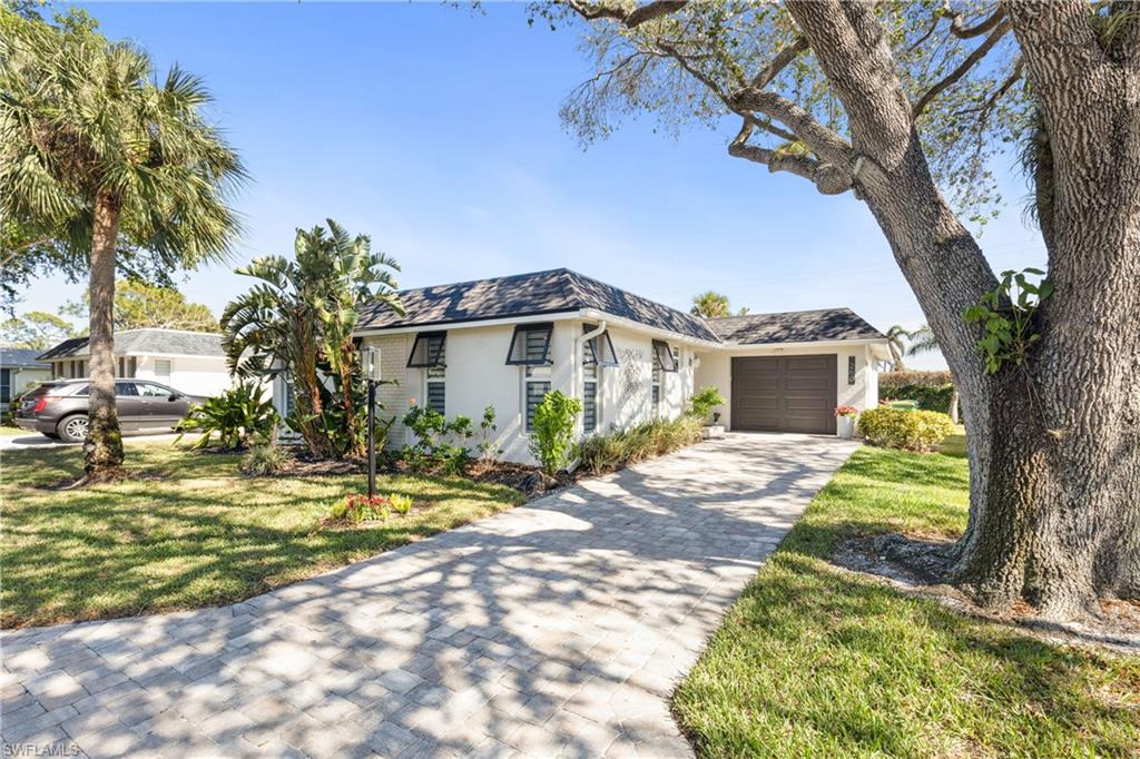 View of front of home featuring a garage and a front lawn