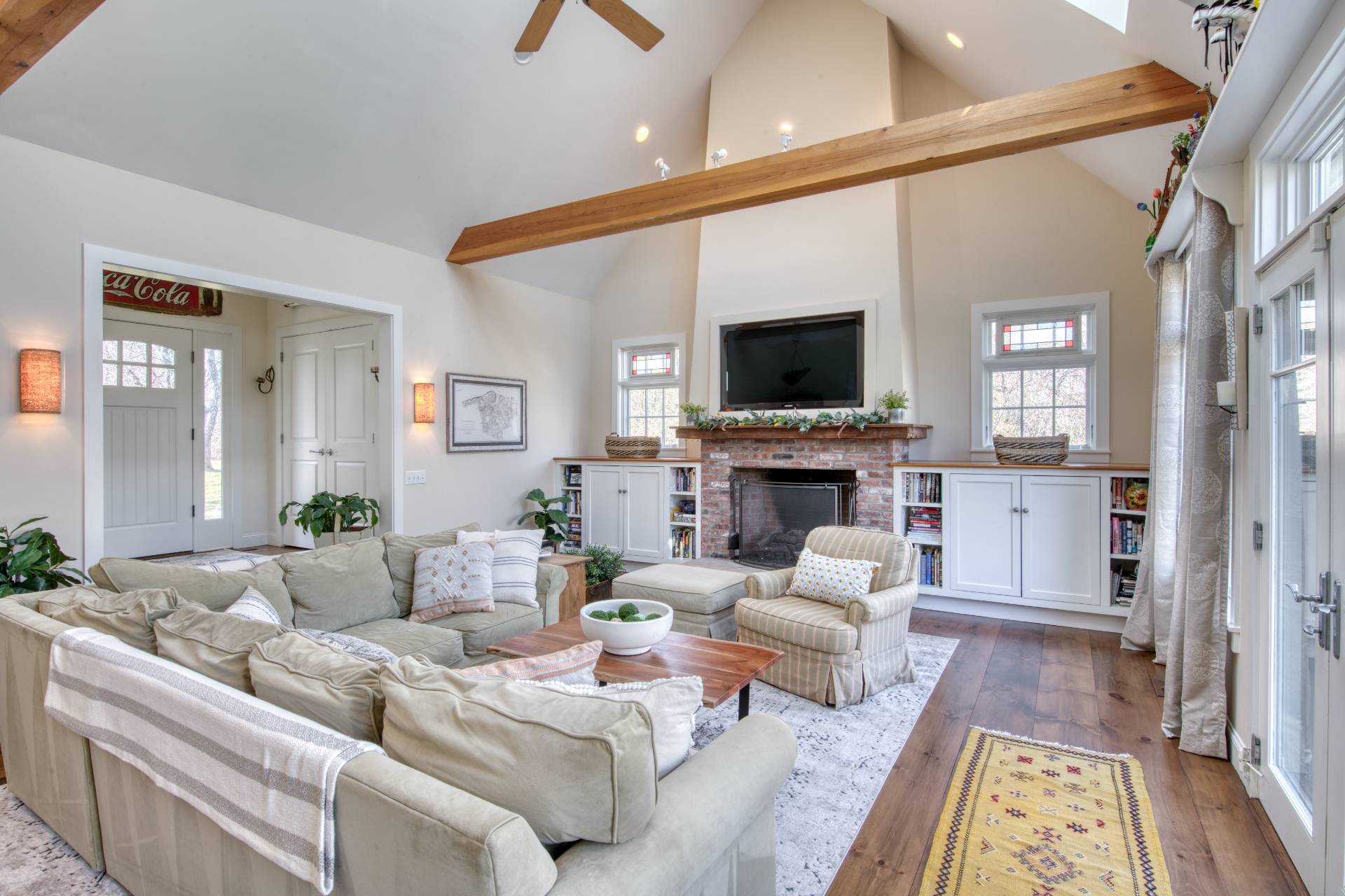 a living room with furniture a fireplace and a flat screen tv