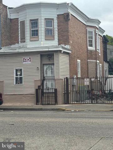 a front view of a house with a street