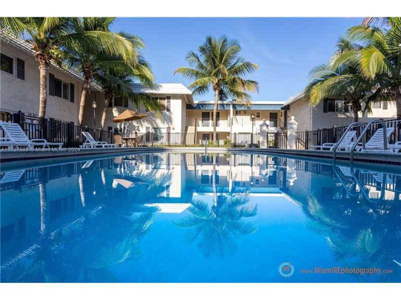 a swimming pool view with a garden space