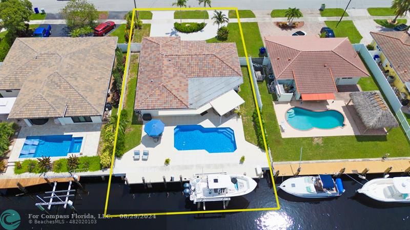 an aerial view of a house with yard swimming pool and outdoor seating