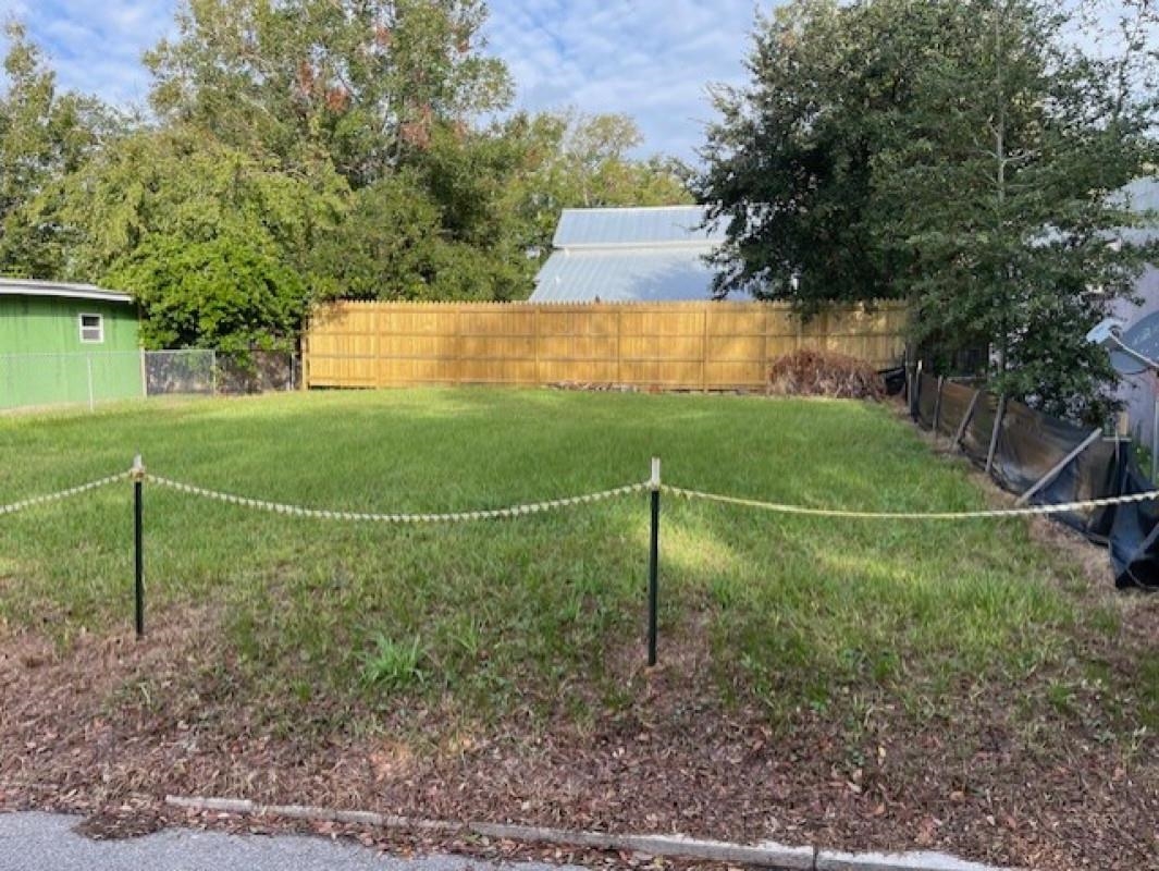 a backyard of a house and trees