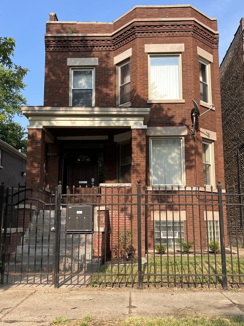 a view of a house with a iron gate