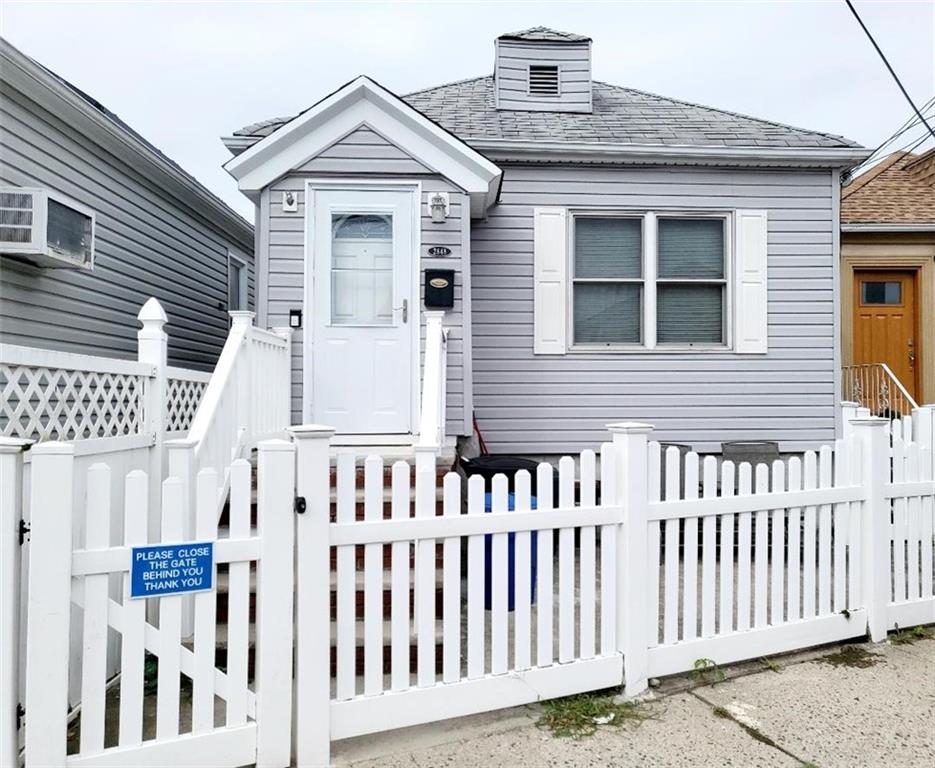 a view of a house with wooden fence