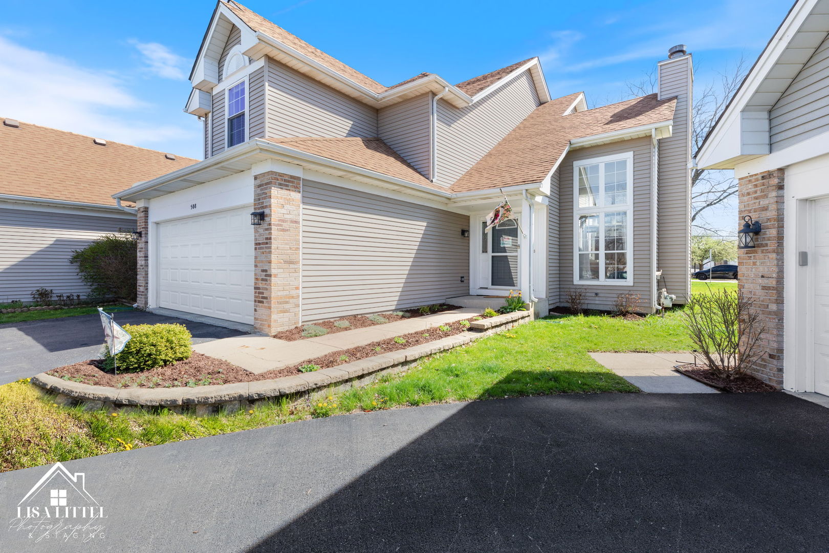 a view of a house with a small yard and plants