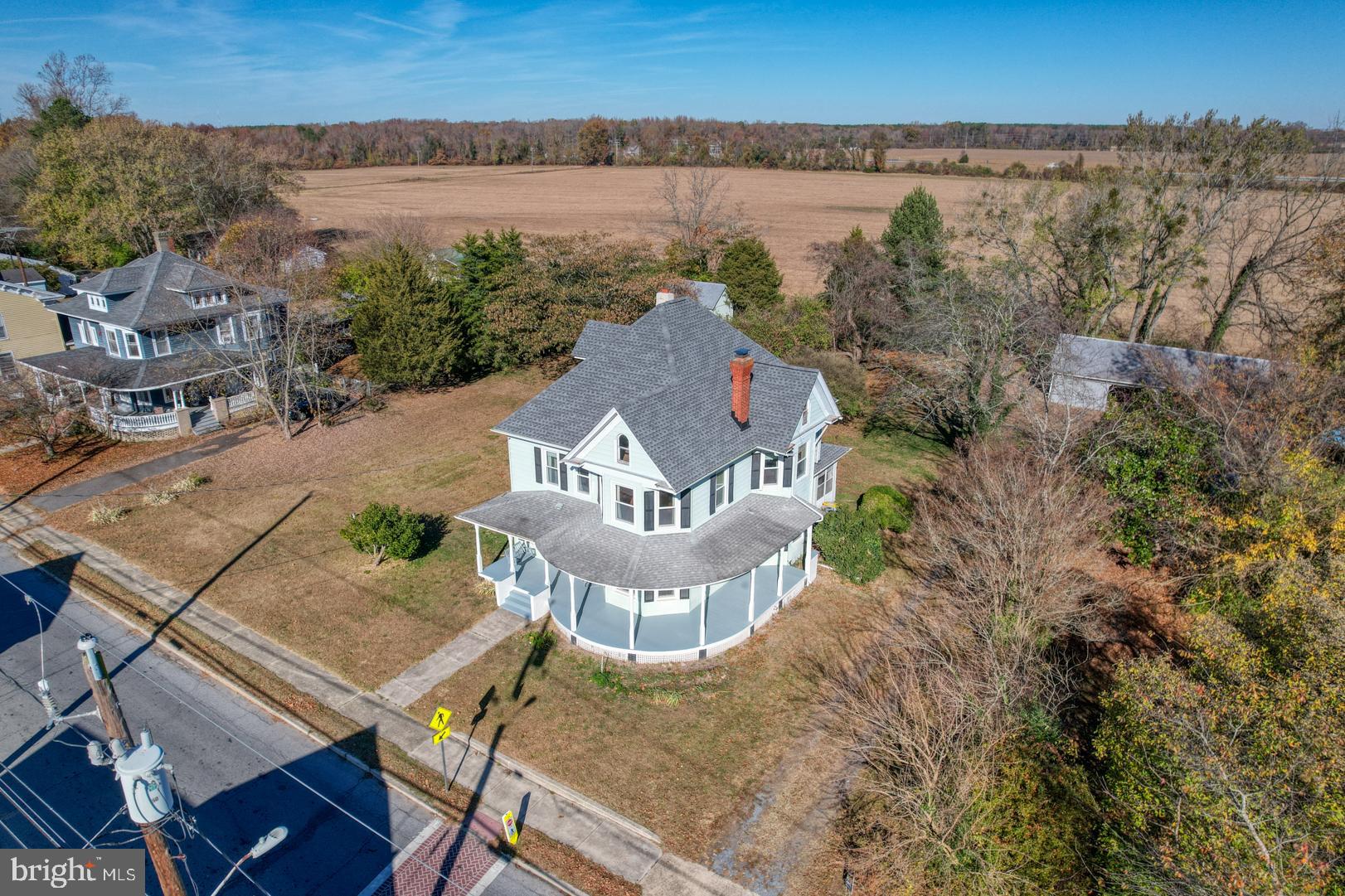 an aerial view of a house with a yard and lake view