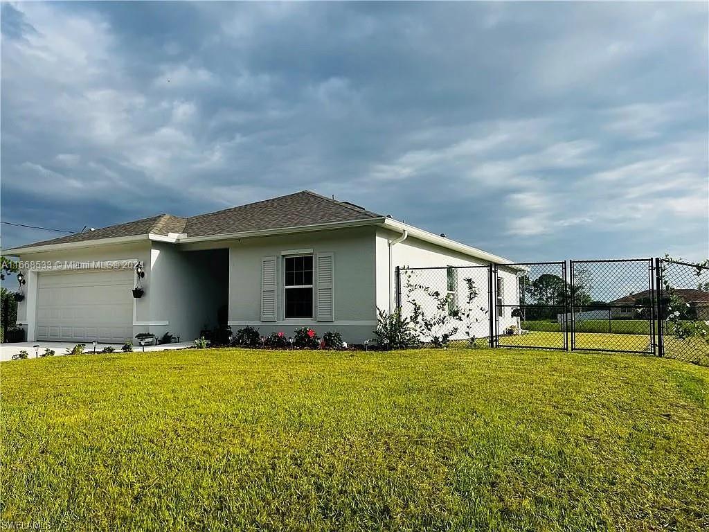 a view of a house with yard and sitting area