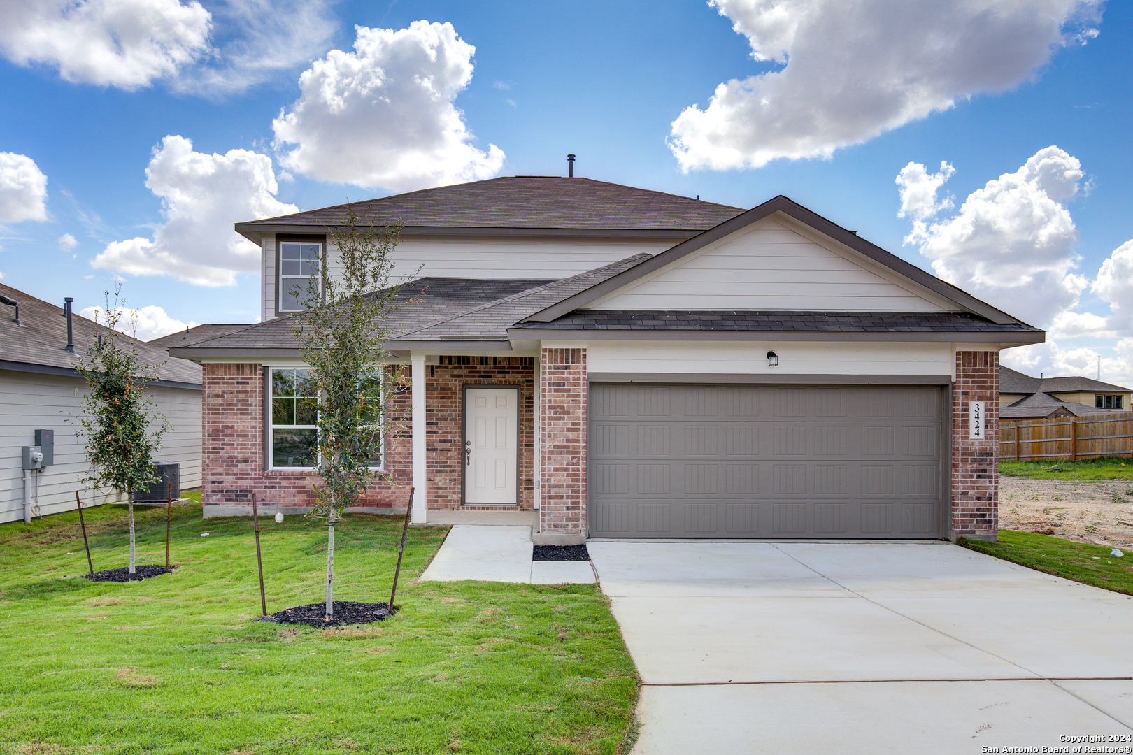 a front view of a house with a yard and entertaining space