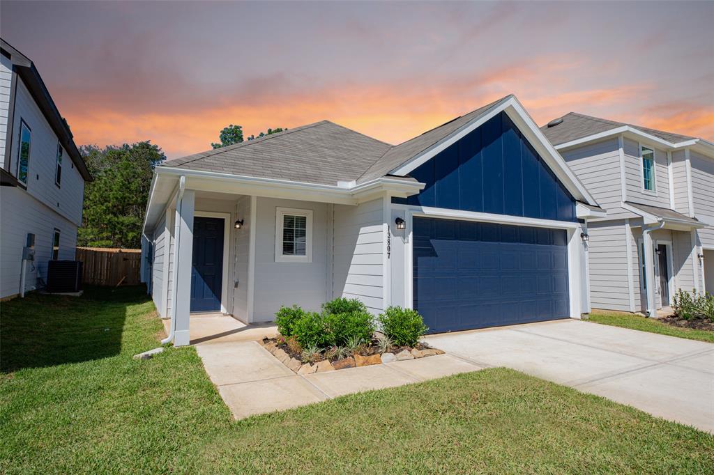 a front view of a house with a yard and garage