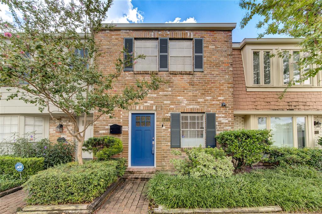 The townhouse front elevation showcases a modern, solid wood door with sleek hardware. The design balances contemporary elements with classic architecture.