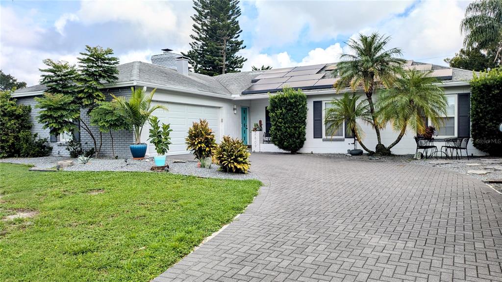 a view of a house with a yard and a patio