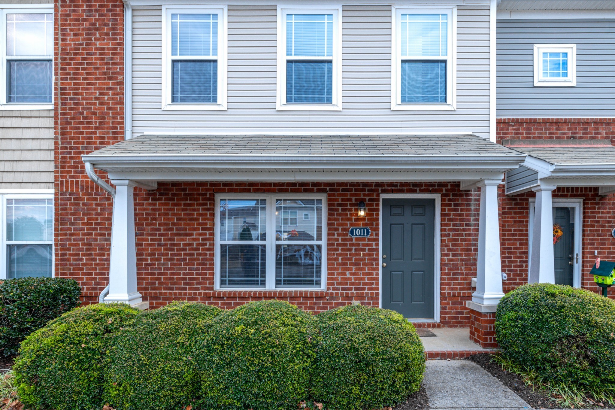 a view of a brick house with a large windows