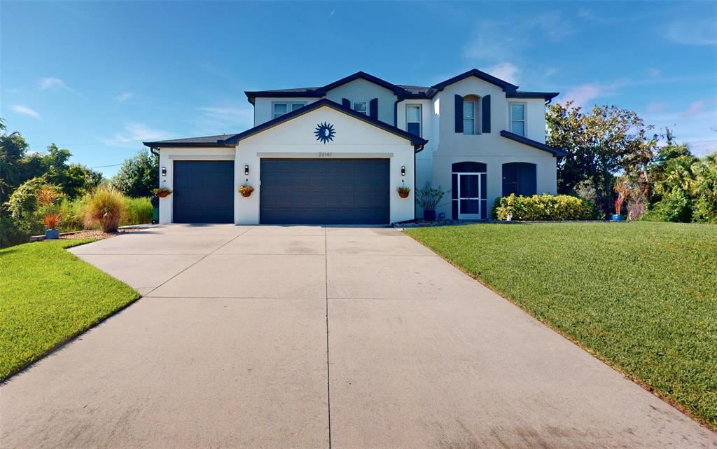 a front view of a house with a yard and garage