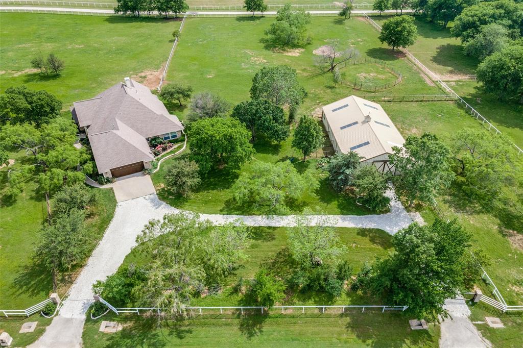 house, barn, newly graveled driveways, 2 gates, newly painted pipe fencing, fruit & nut bearing trees