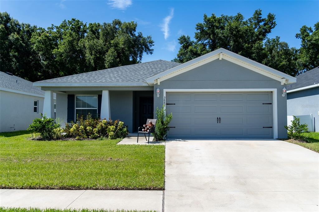 a front view of a house with a yard and garage