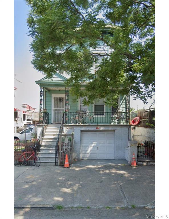 View of front facade featuring a garage