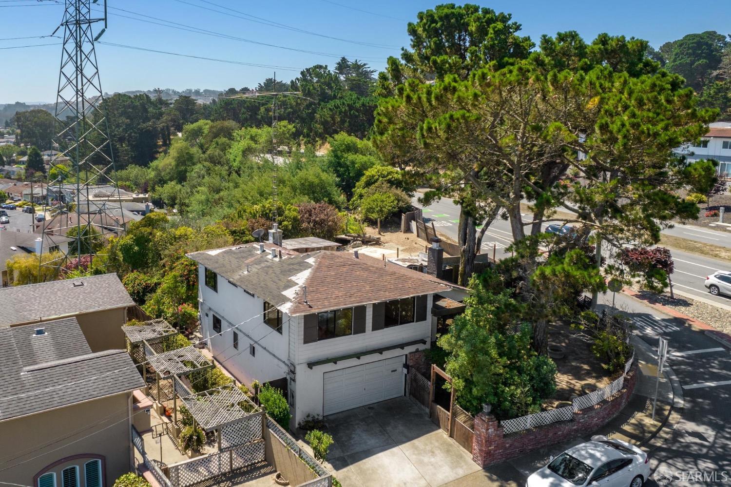 an aerial view of a house with a yard