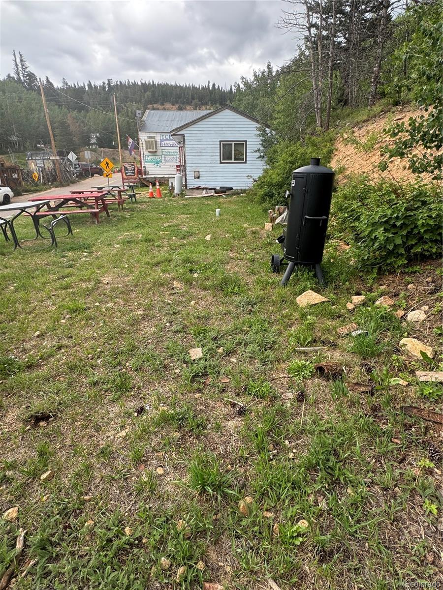 a view of a house with a yard and sitting area