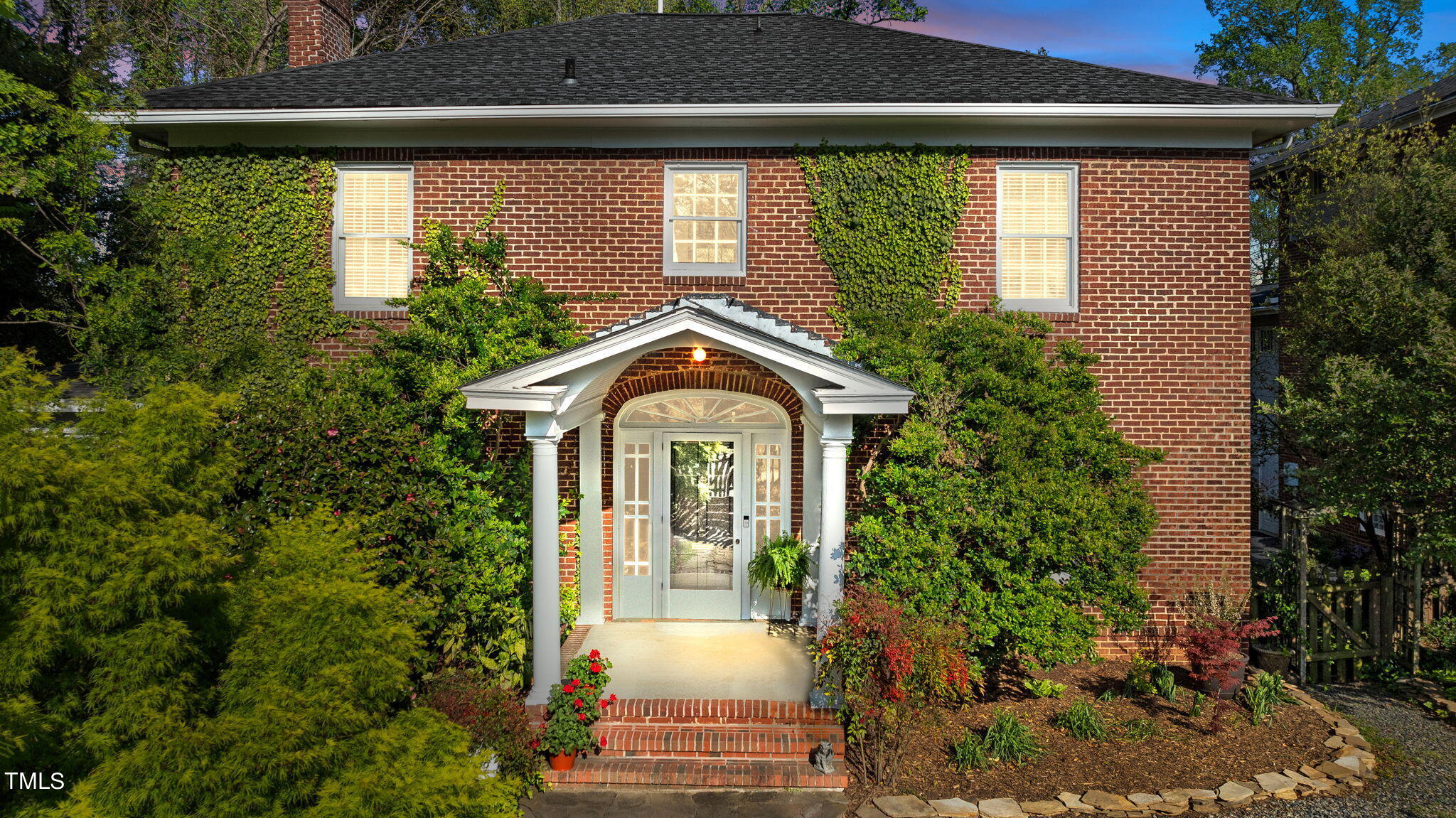 a front view of a house with garden