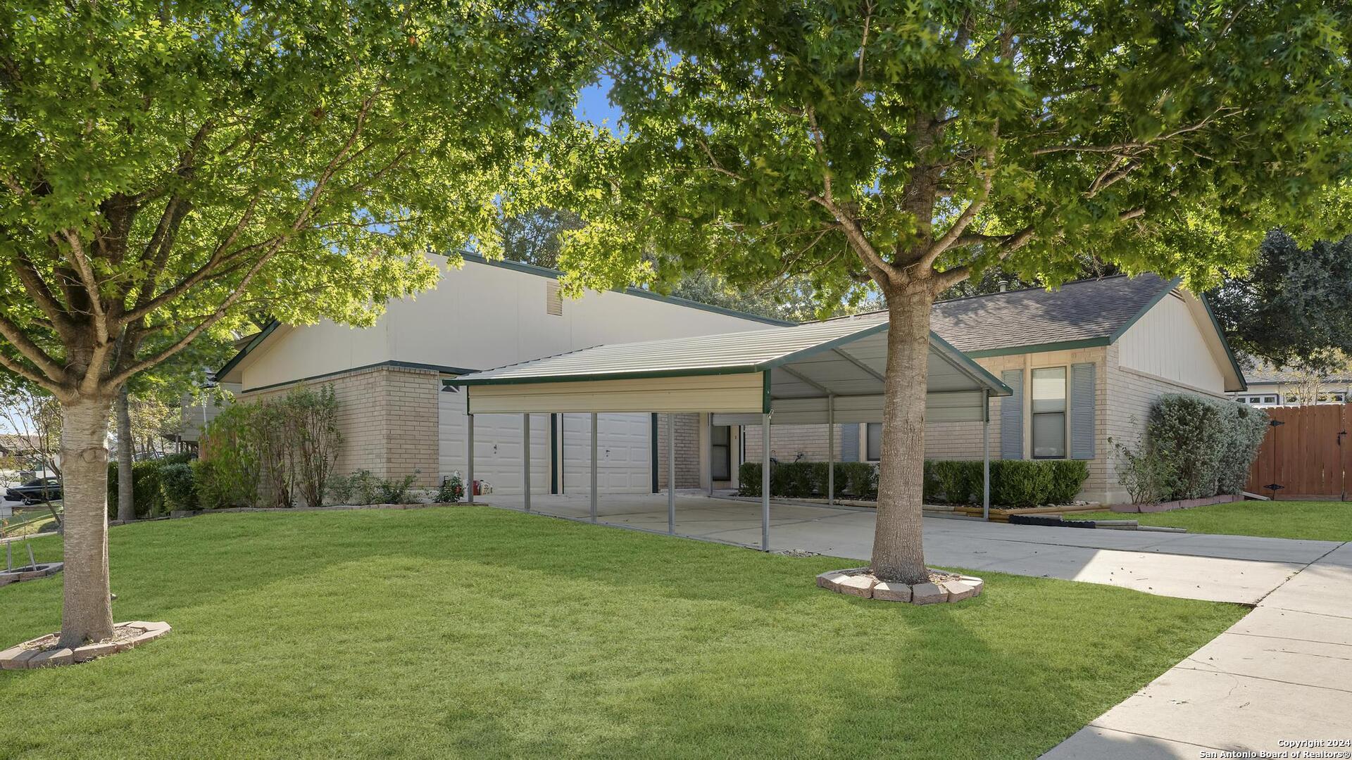 a front view of house with yard and green space