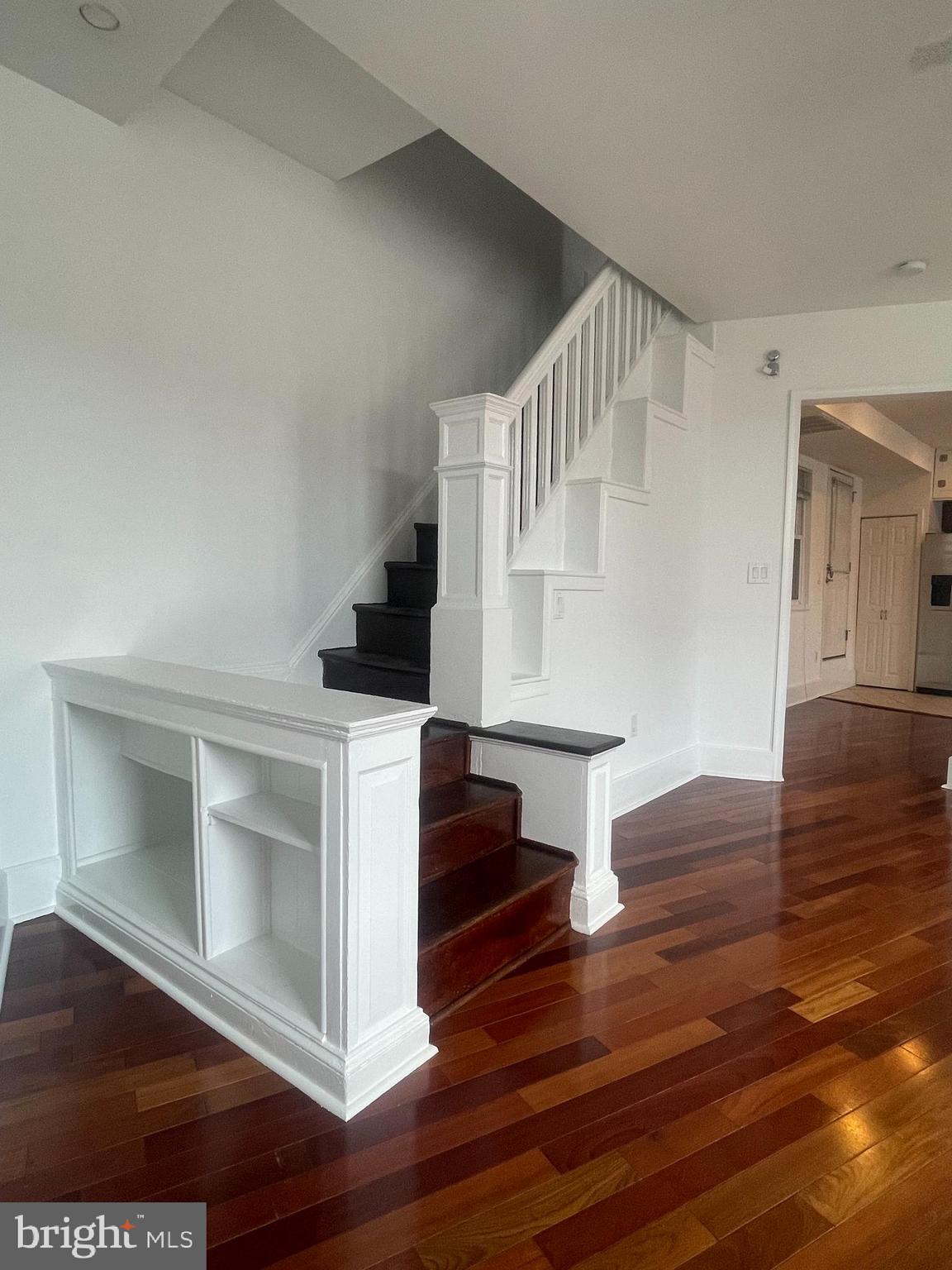 a view of entryway and hall with wooden floor