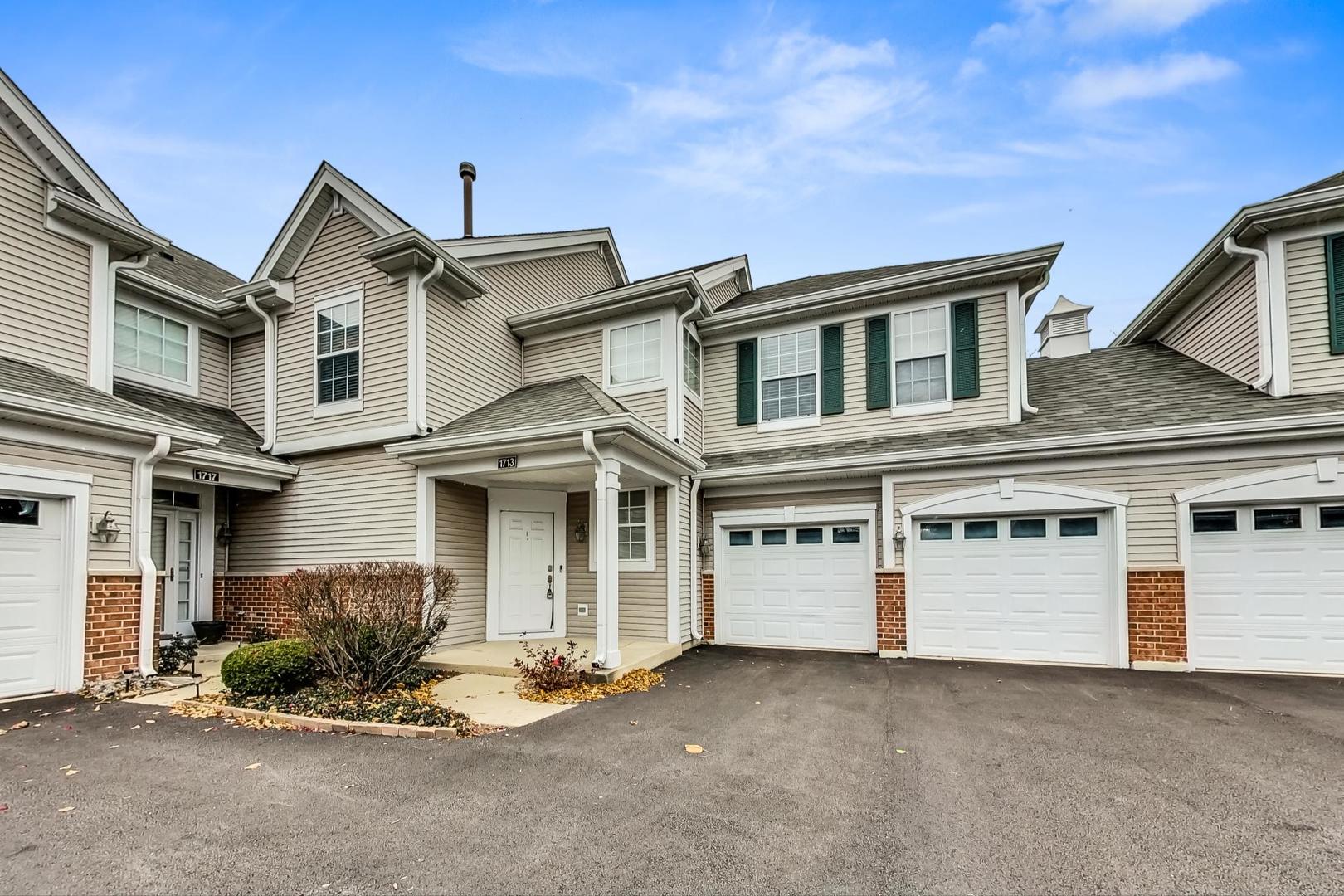 a front view of a house with a garage