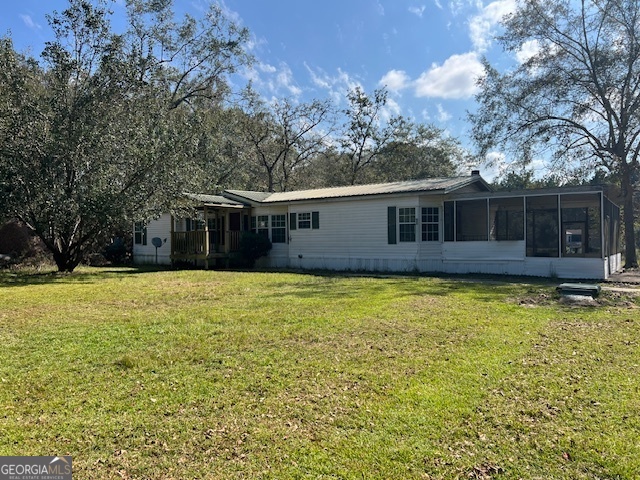 a view of a house with a backyard