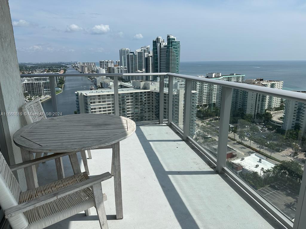 a view of a balcony with wooden floor