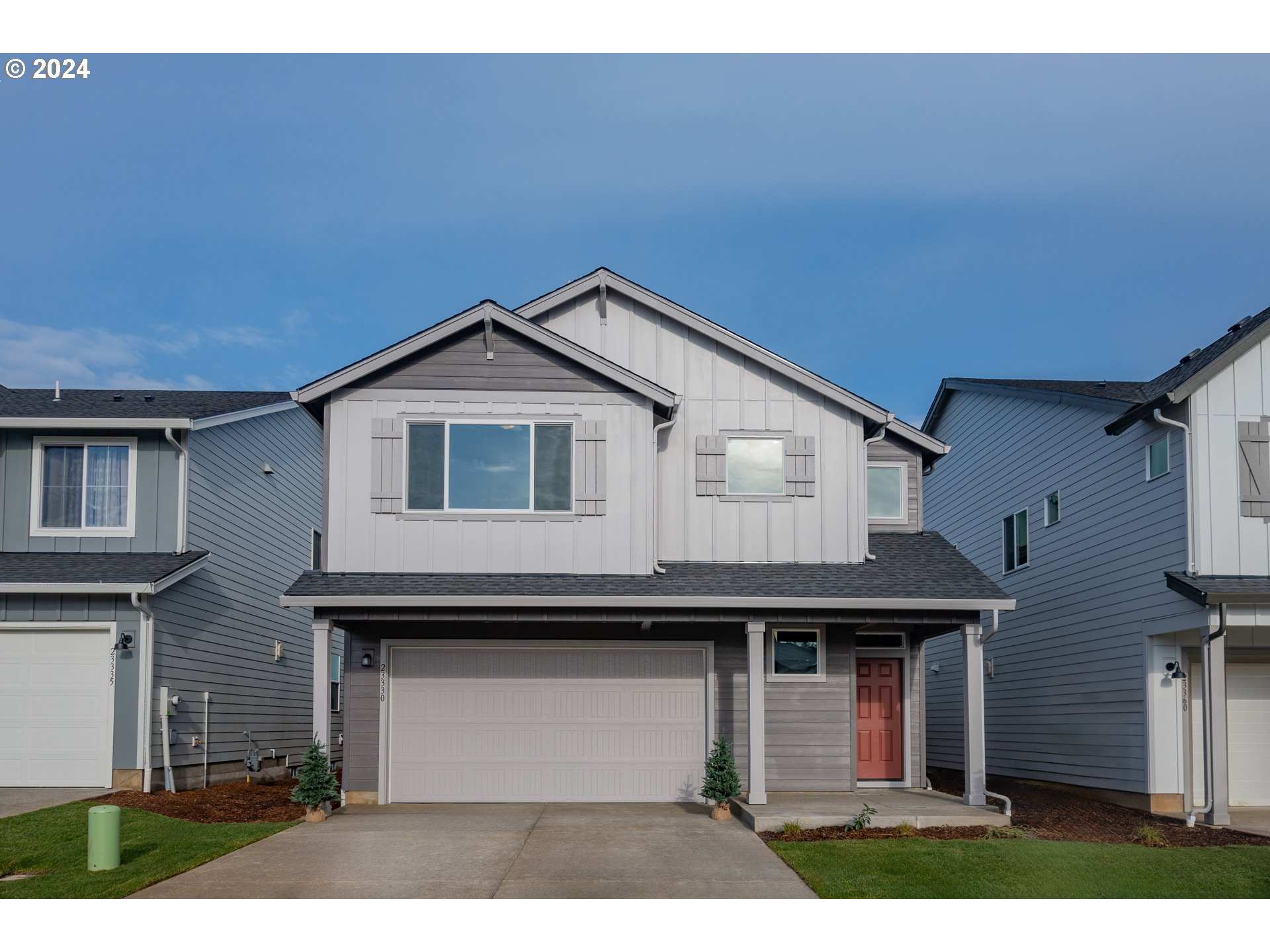 a front view of a house with garage