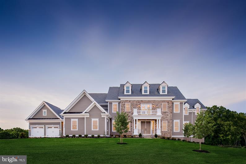 a front view of residential houses with yard and green space