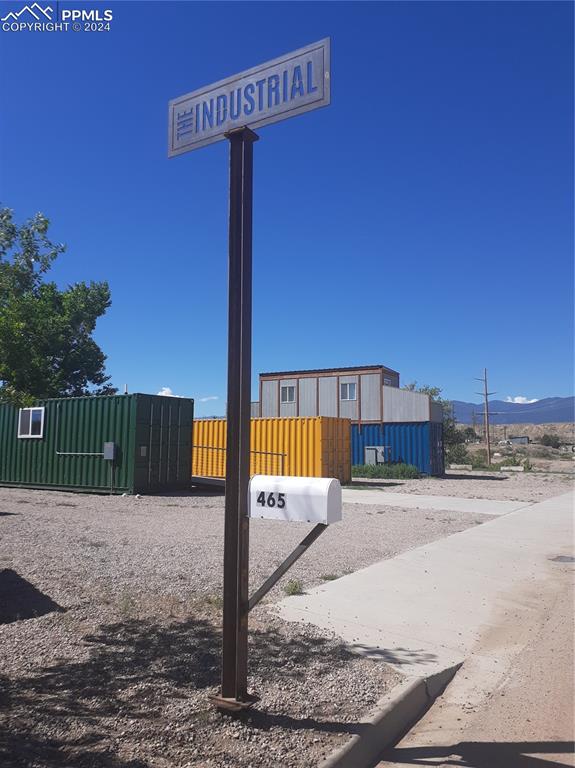 a view of a street with a house in the background