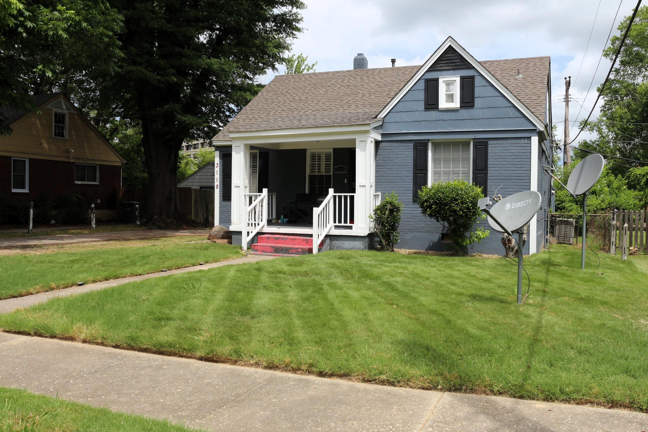 View of front of house featuring a front lawn and a porch