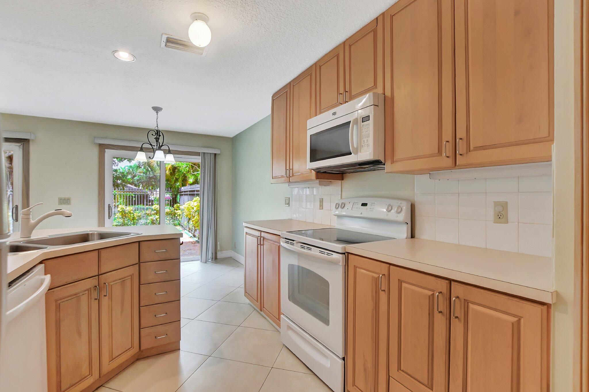 a kitchen with a sink stove and microwave