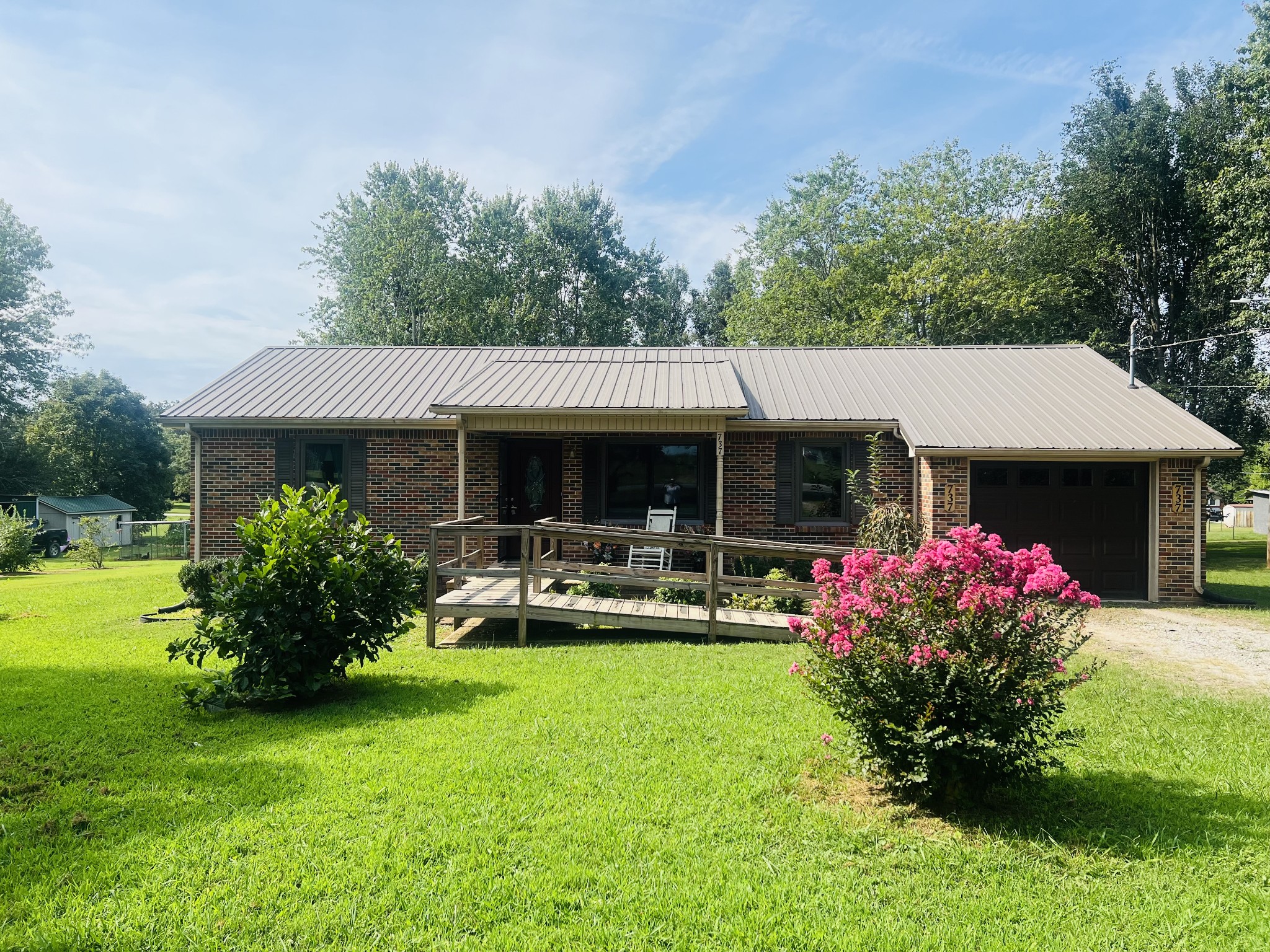 a front view of house with yard and outdoor seating