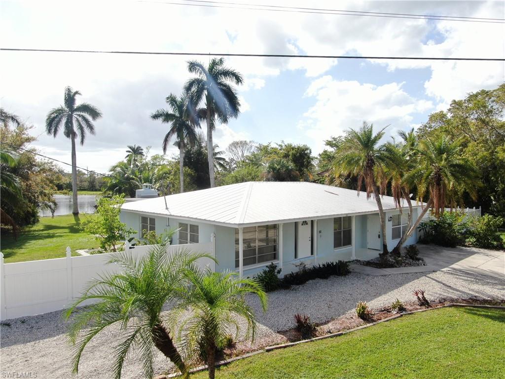 Ranch-style home featuring a front yard and a water view