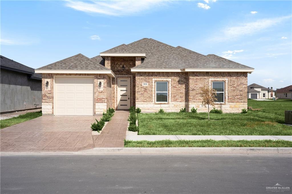 Prairie-style house with a front lawn and a garage