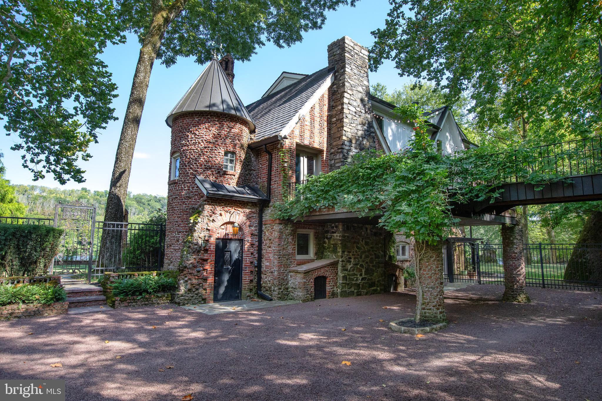 a front view of a house with a tree