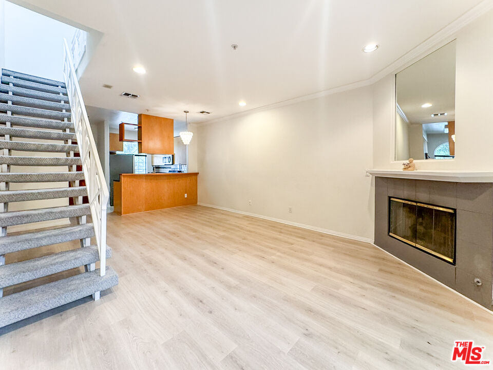 a view of kitchen and hall with wooden floor