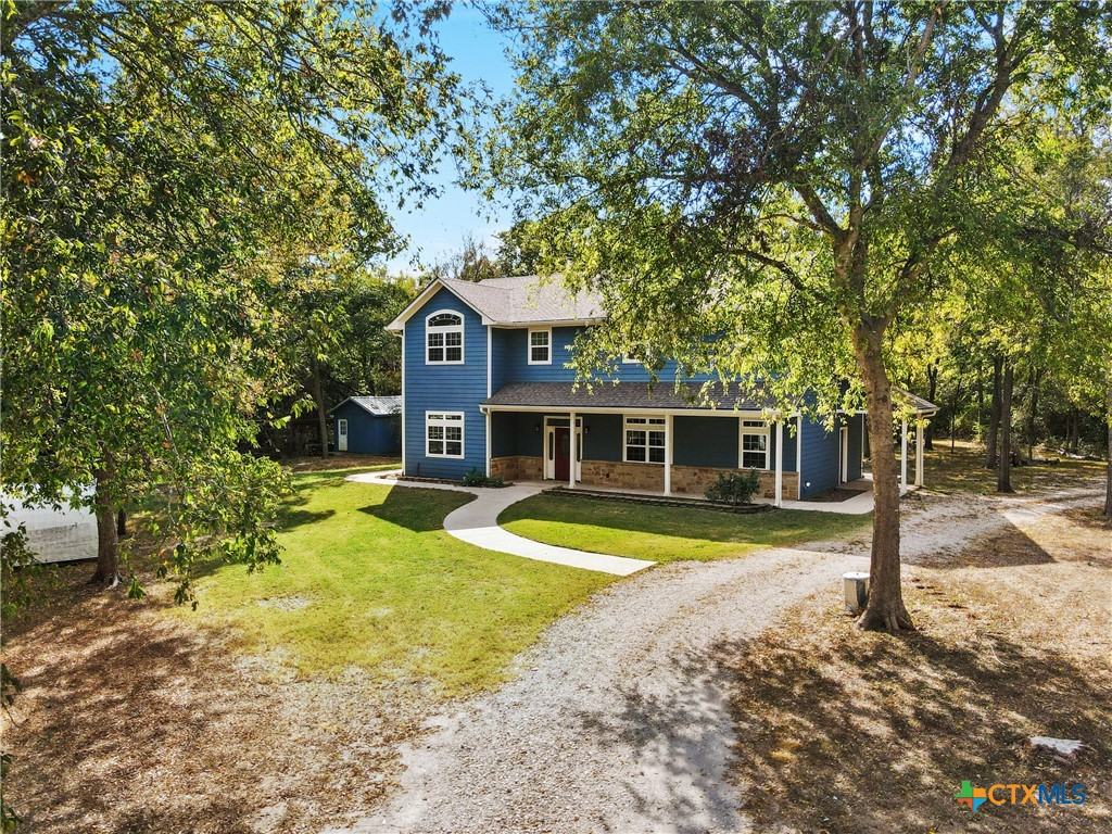 a view of a house with swimming pool next to a yard