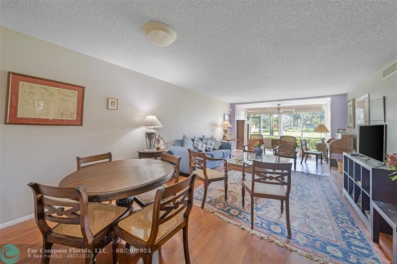 a dining room with furniture and wooden floor