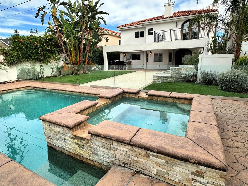 a view of house with swimming pool and chairs