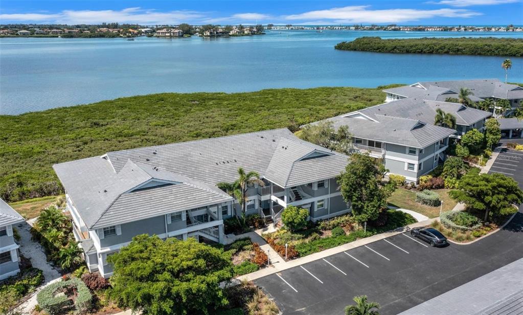 an aerial view of a house with garden space and lake view