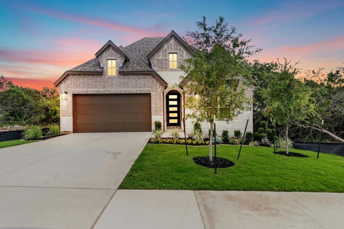 a front view of a house with a garden