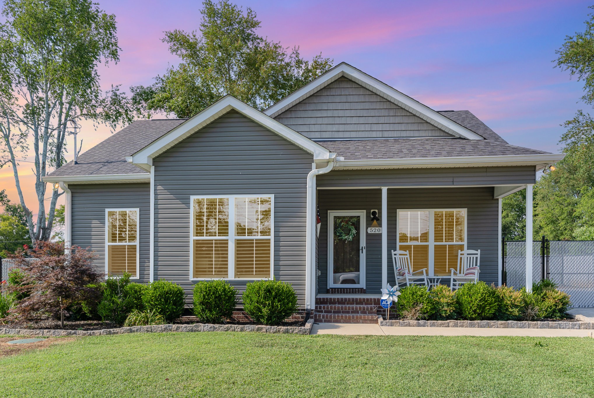 a front view of a house with a yard