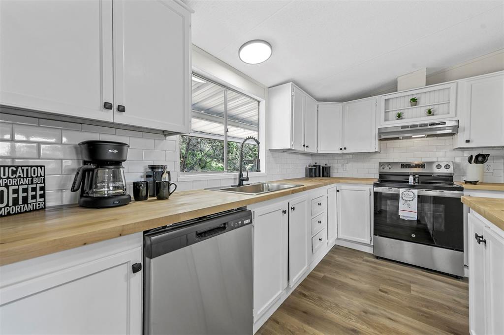 a kitchen with kitchen island white cabinets and white appliances