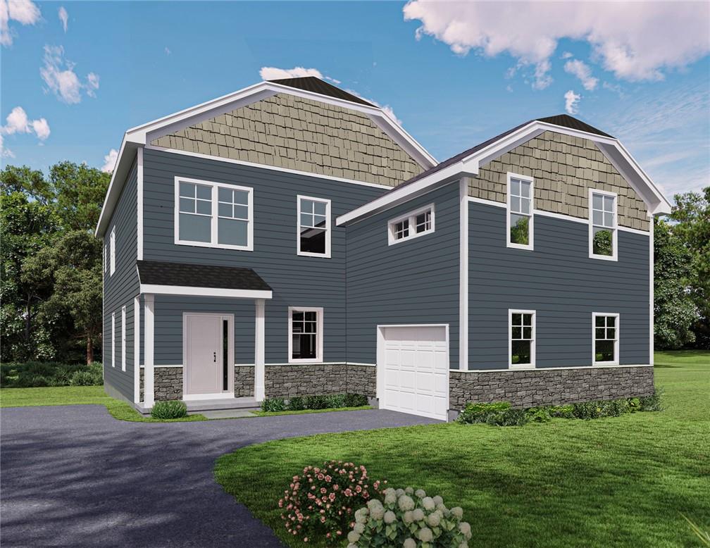 View of front of home featuring a garage and a front yard