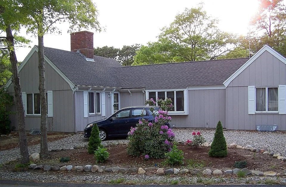 a front view of a house with garden