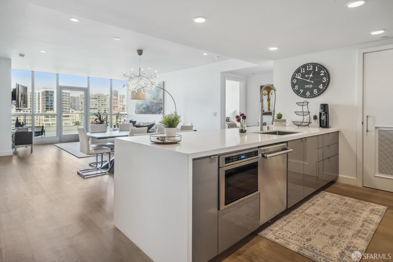 a kitchen with a sink cabinets and wooden floor