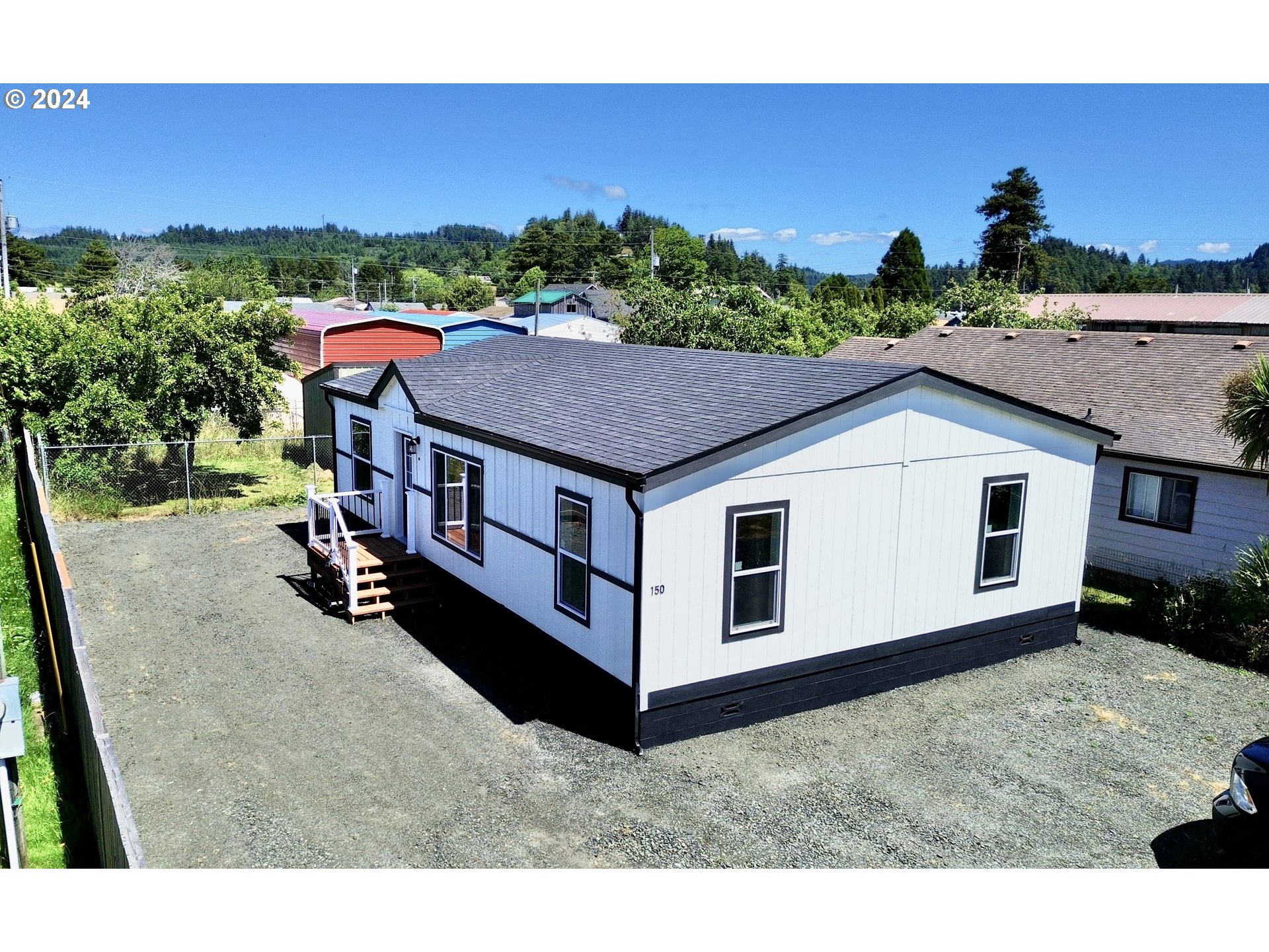 a aerial view of a house with a yard and sitting area