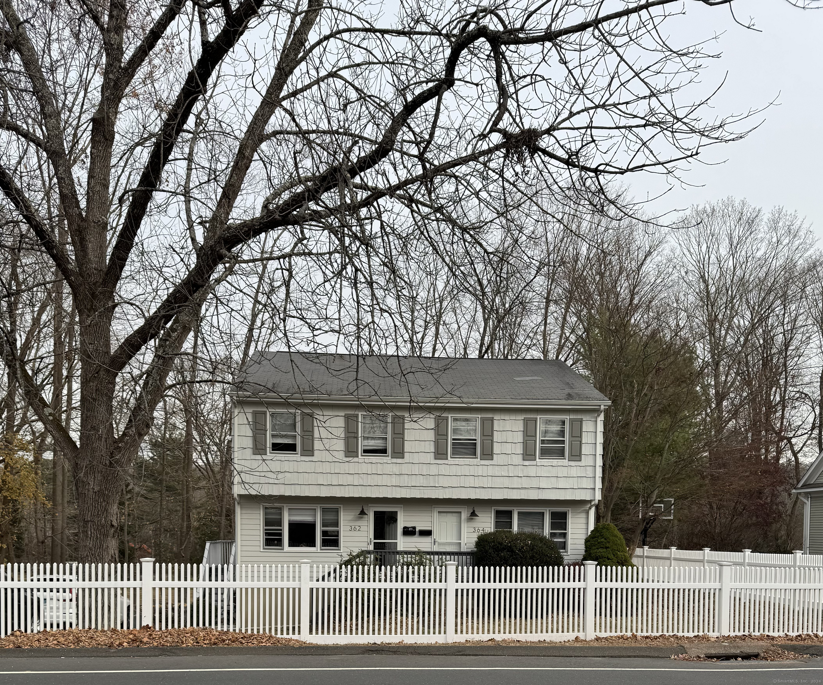 a house that has a tree in front of the house